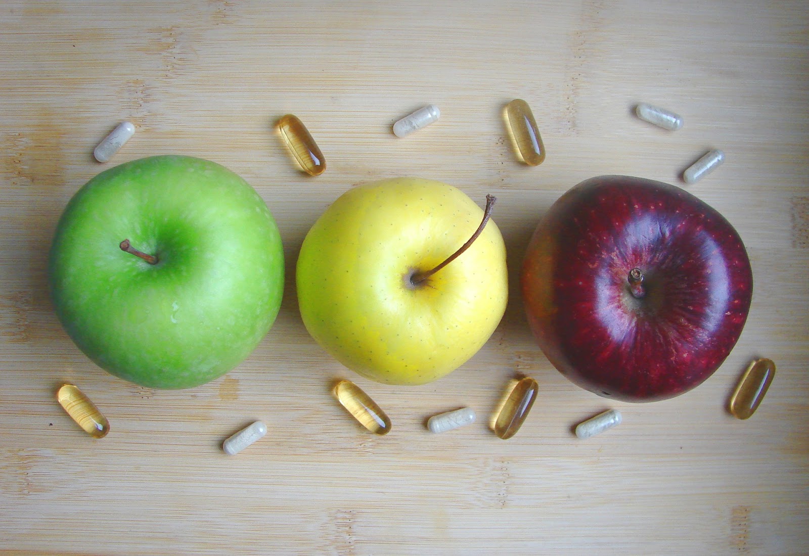 Supplements with apples on table