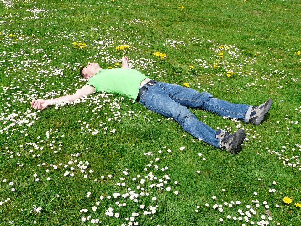 How To Save Your Health During Long Rides laying in grass