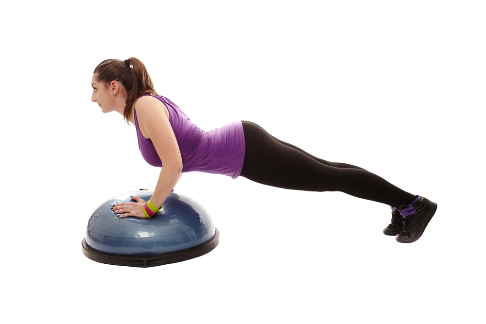 woman balancing on exercise pad